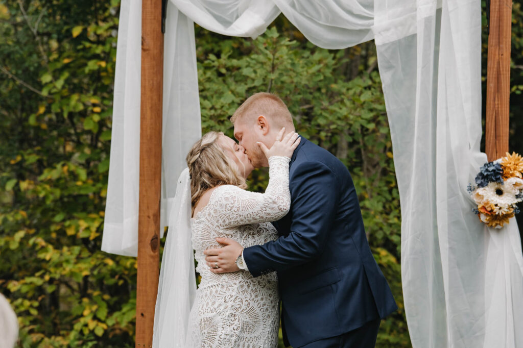 bride and groom kissing during ceremony