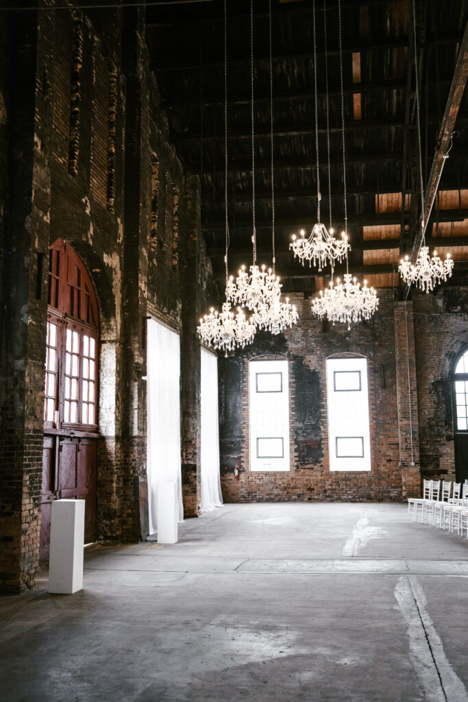 Exposed brick, chandeliers, and large windows