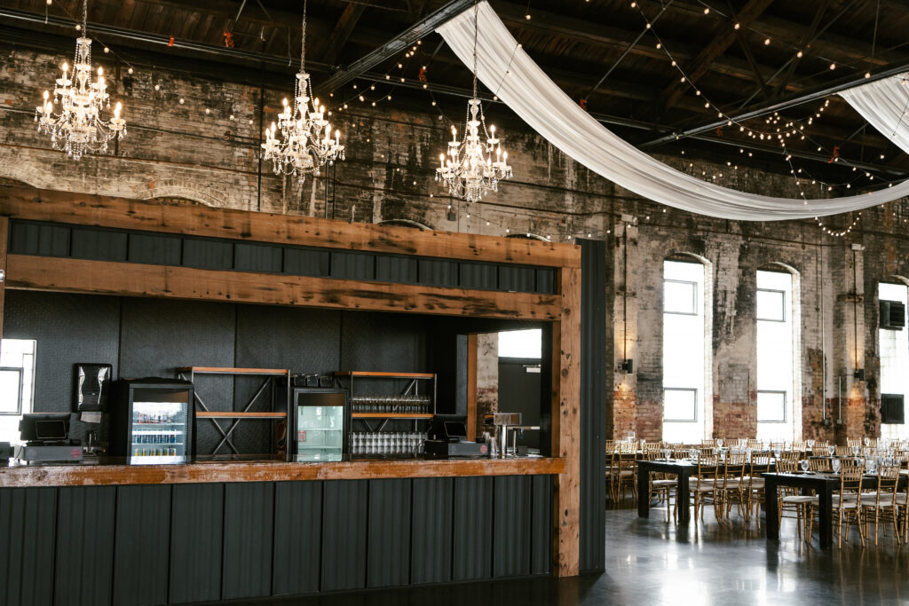 Wedding venue bar area that is black with wooden trim